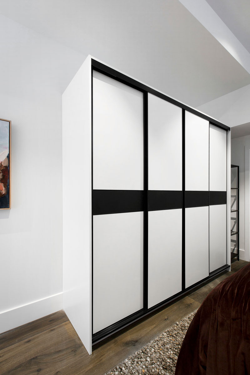 Sliding wardrobe with black and white doors