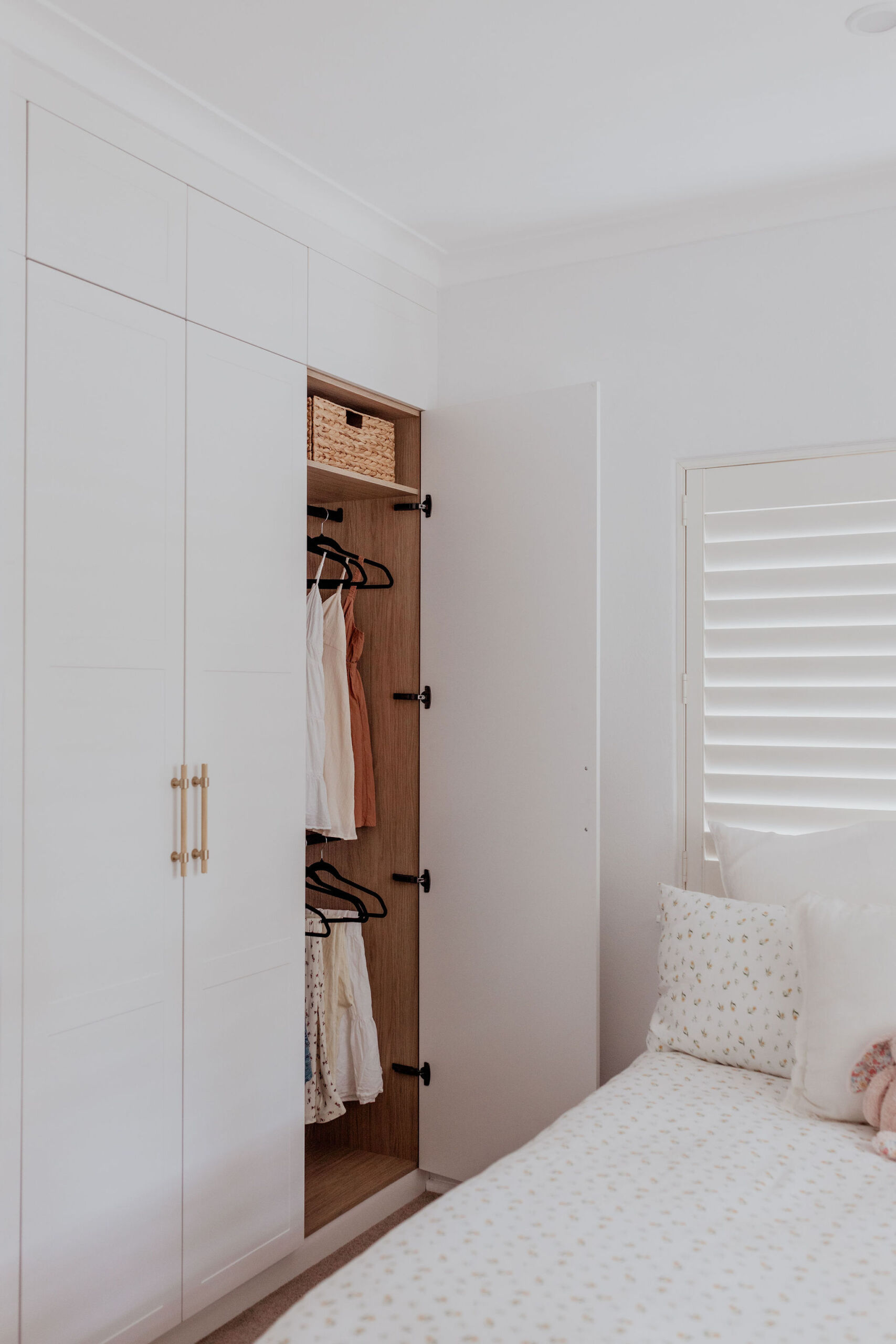 097A2404 Hamptons style wardrobe with shaker-look wardrobe doors with gold handles and timber-look internal finishes.